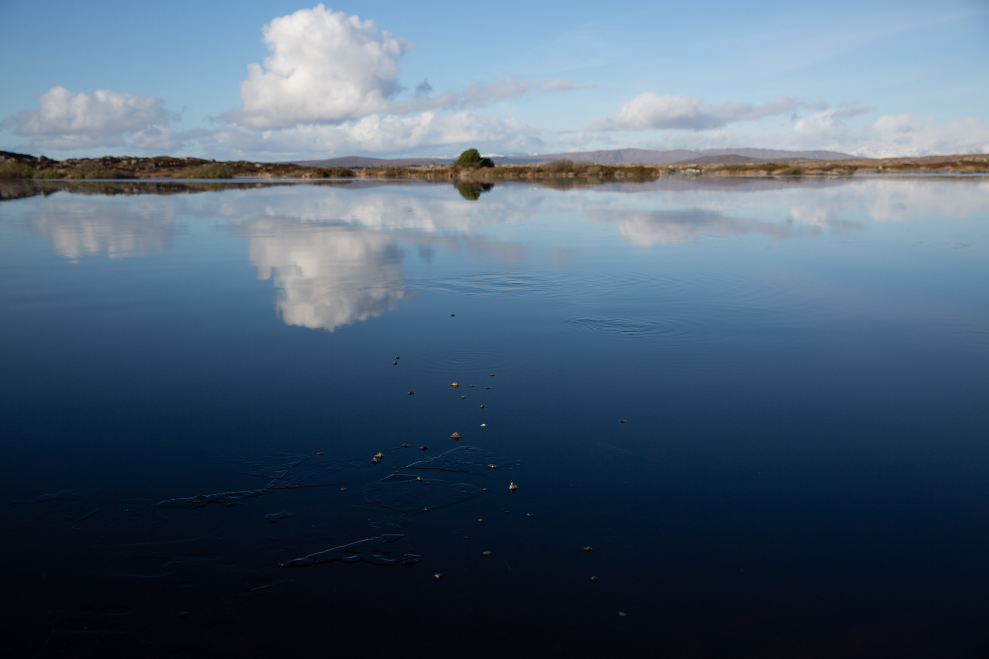 Reflections on the ice. Loch Awalia,.  Handful of stones.